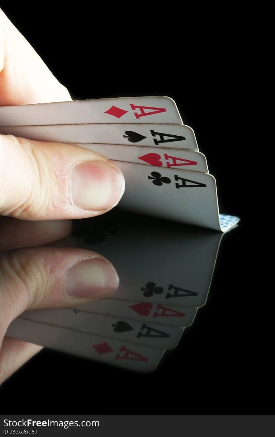 Four aces in poker isolated on a black background