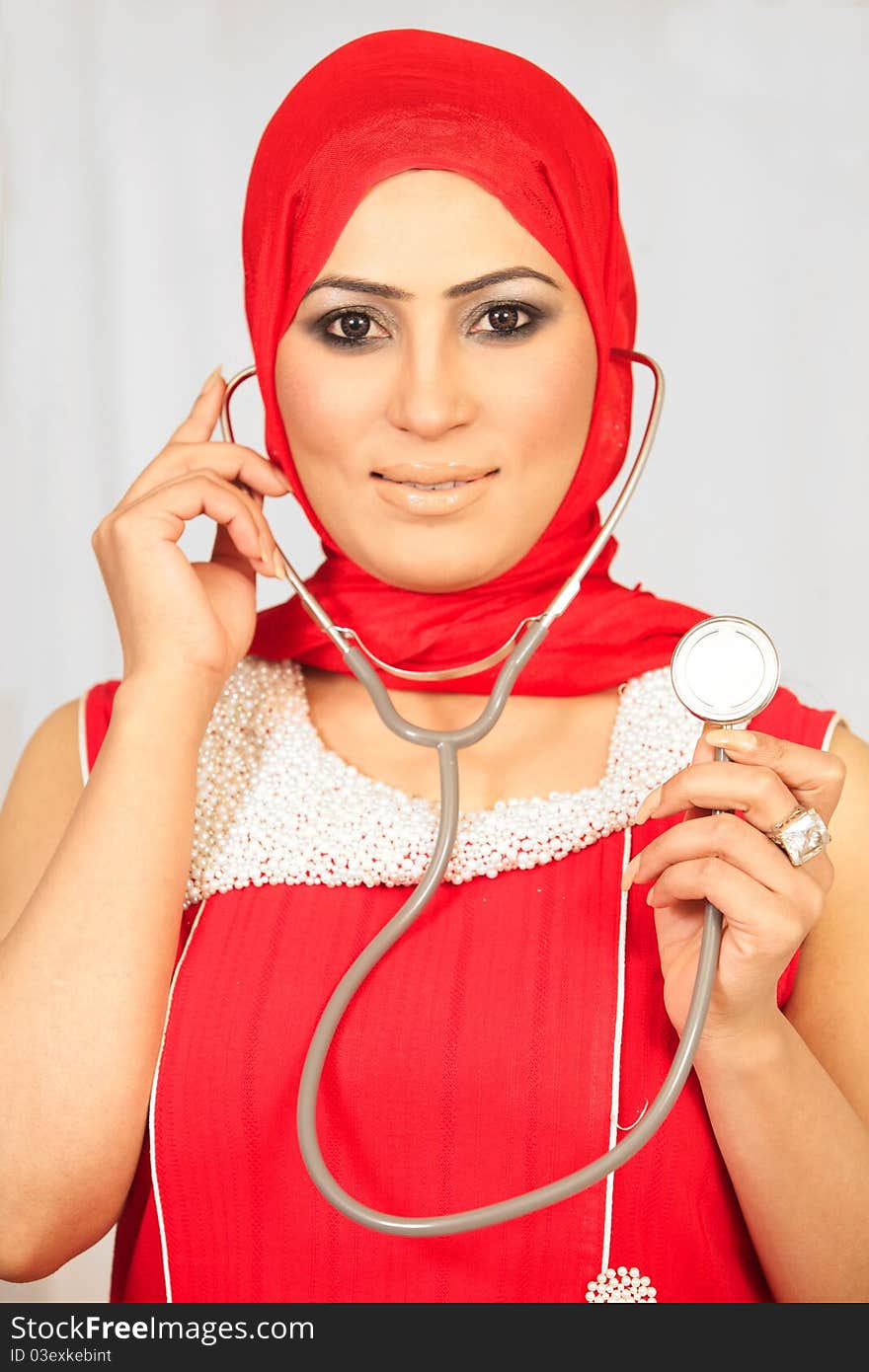 Smiling medical doctor woman with stethoscope. Isolated over white background