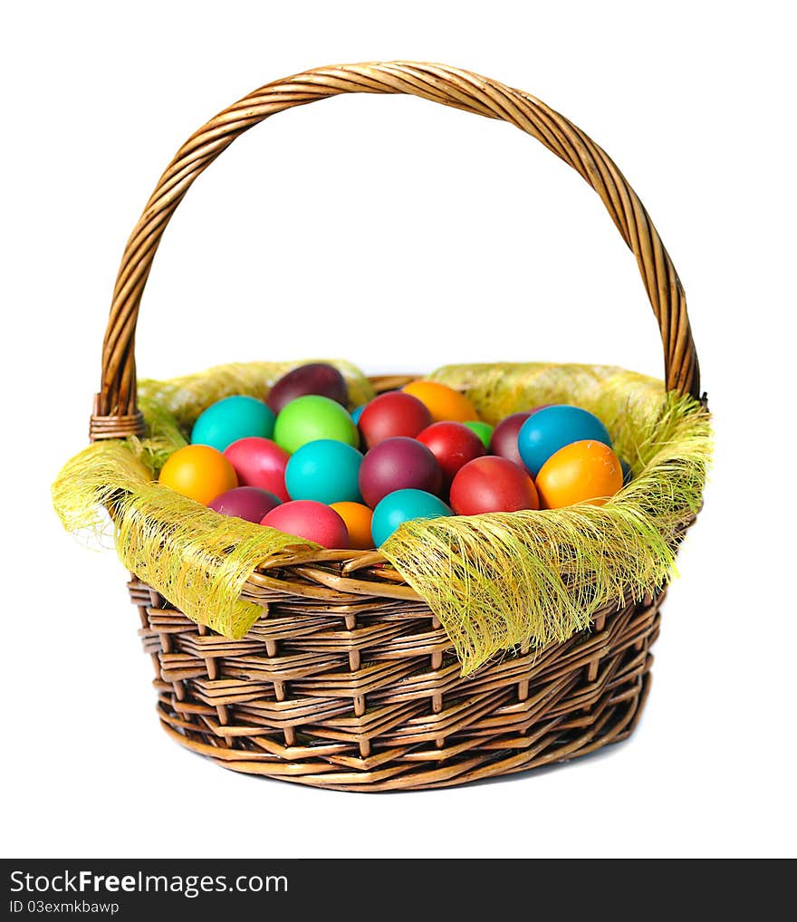 Easter eggs in basket with white lily on white background