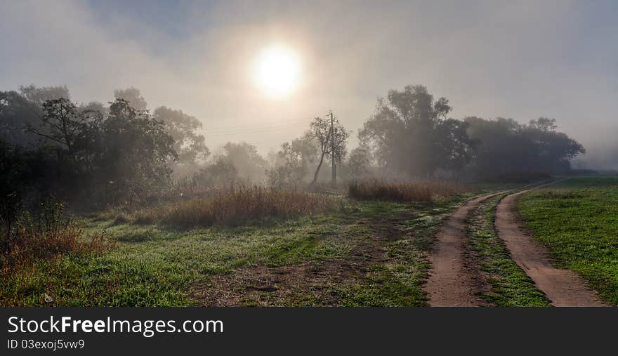 Russian field and country road at sunrise