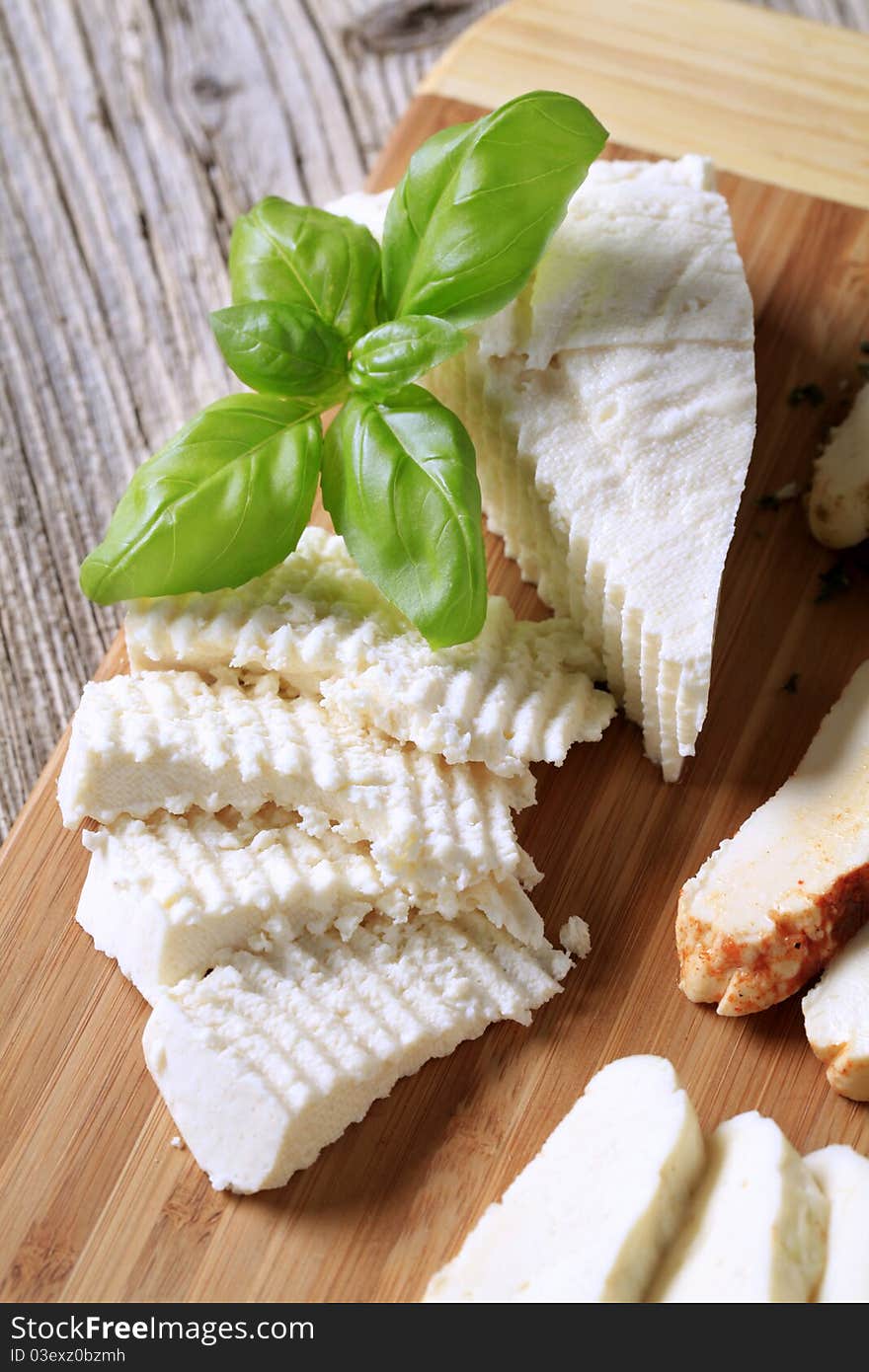 Slices of feta cheese on a cutting board