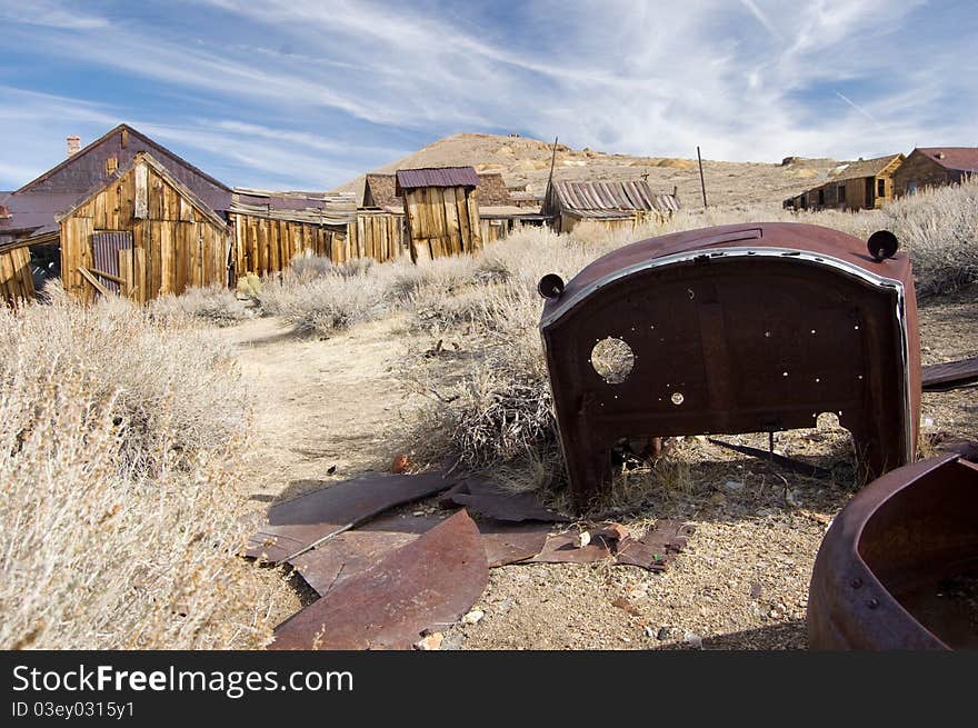 A rusty old car in a ghost town in California. A rusty old car in a ghost town in California.