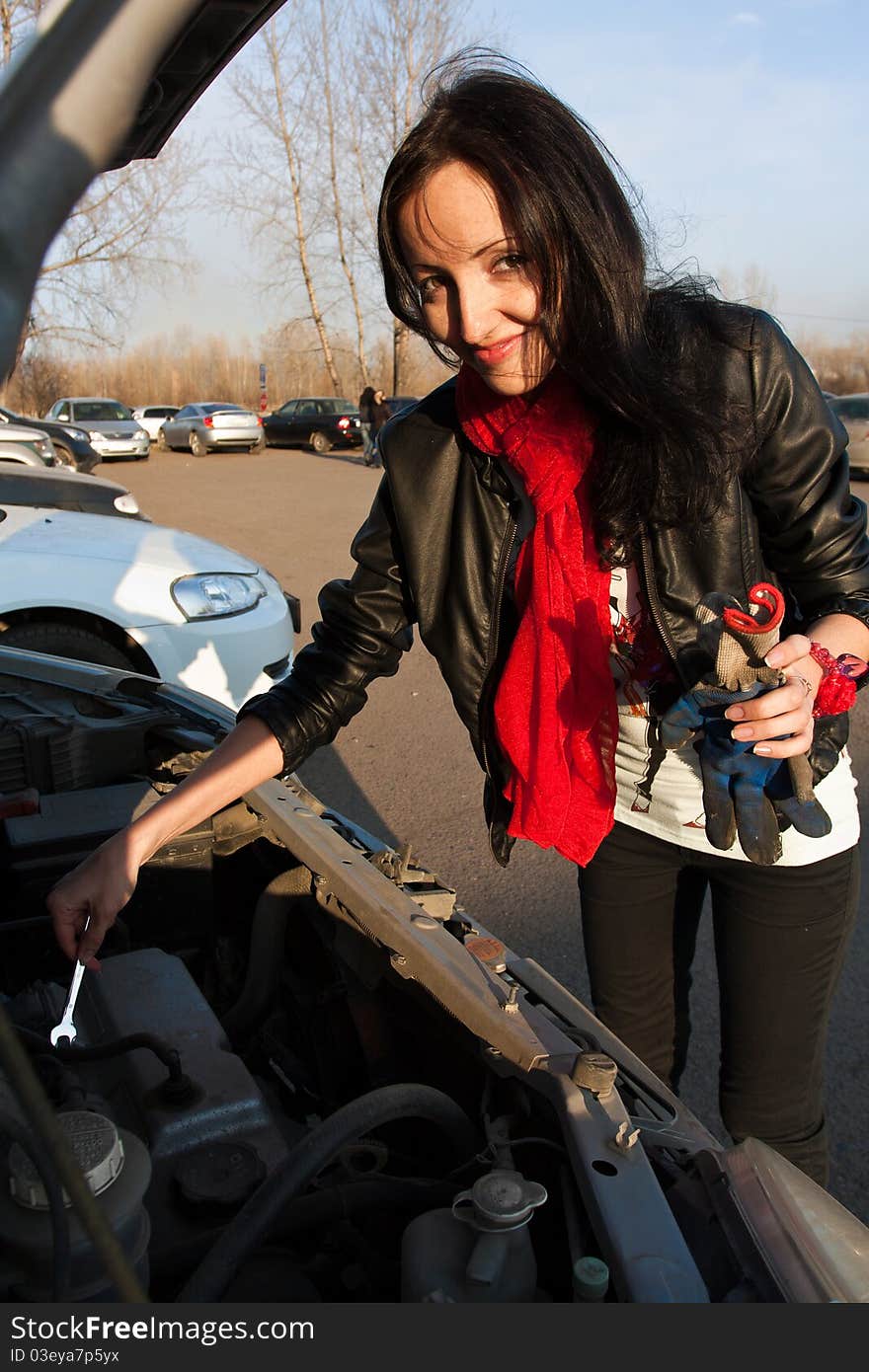 Woman Repairing The Car