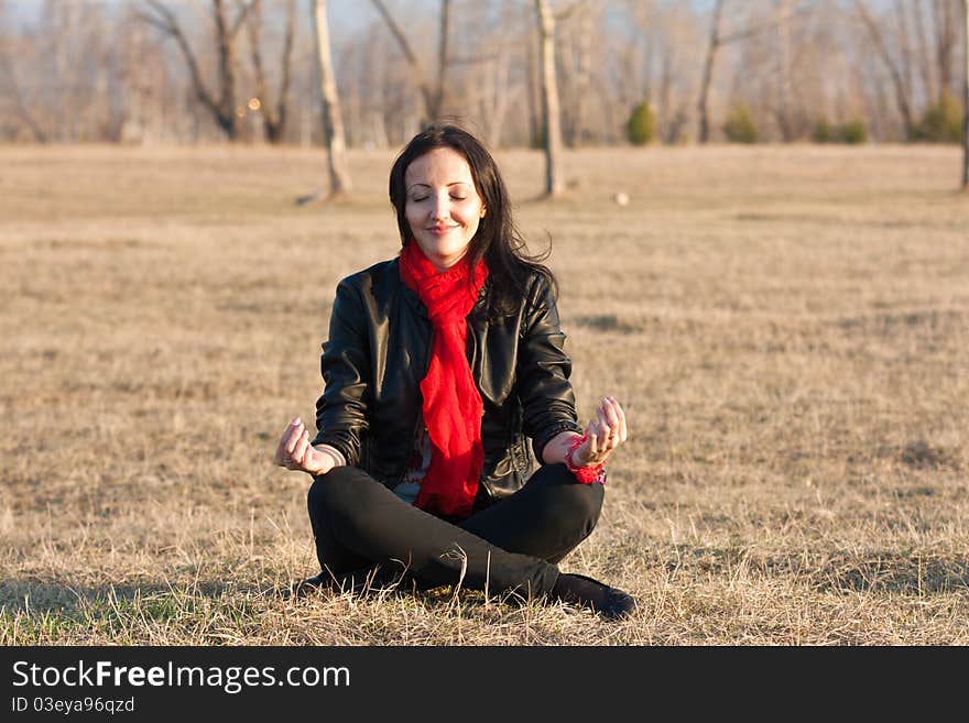 Girl Meditates On A Grass