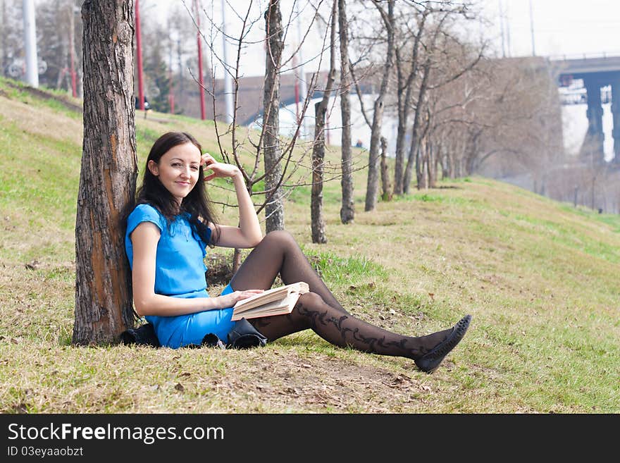 Girl reading book in spring park