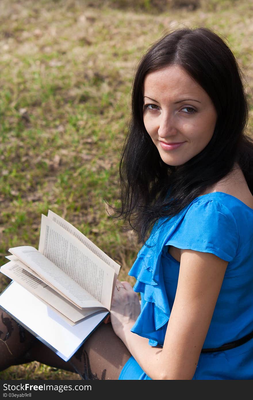 Girl reading book in spring park