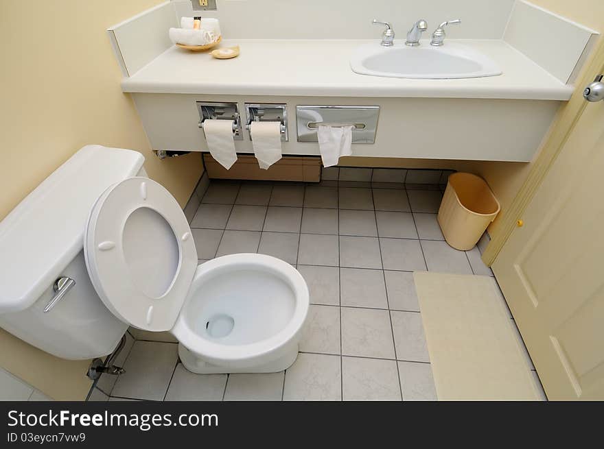 Bright and white toilet area and wash basin.