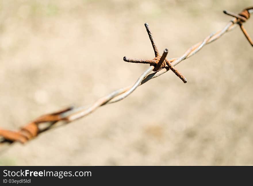 Barbed wire is coated with rust, close-up. Barbed wire is coated with rust, close-up.