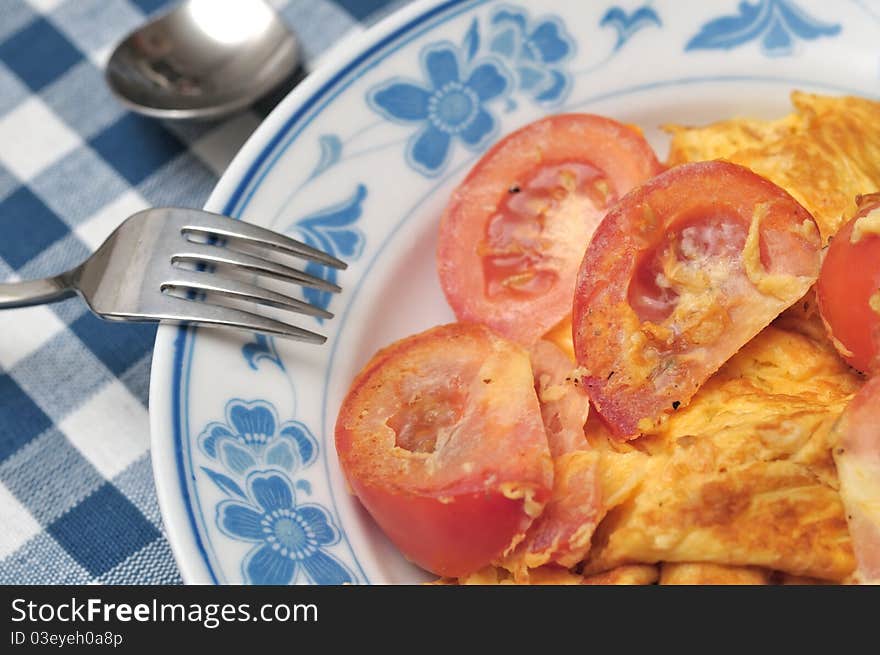 Chinese style egg omelet fried with fresh raw tomatoes. Chinese style egg omelet fried with fresh raw tomatoes.