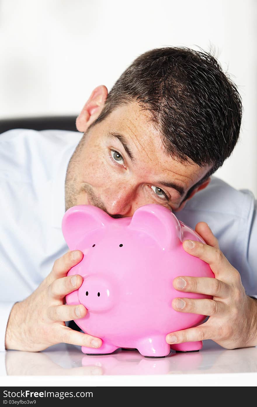 Beautiful man with pink piggy bank. Beautiful man with pink piggy bank