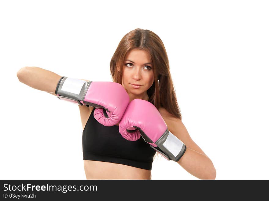 Pretty young boxing woman standing and putting her hands in pink and black box gloves together in front of the body isolated on a white background. Pretty young boxing woman standing and putting her hands in pink and black box gloves together in front of the body isolated on a white background