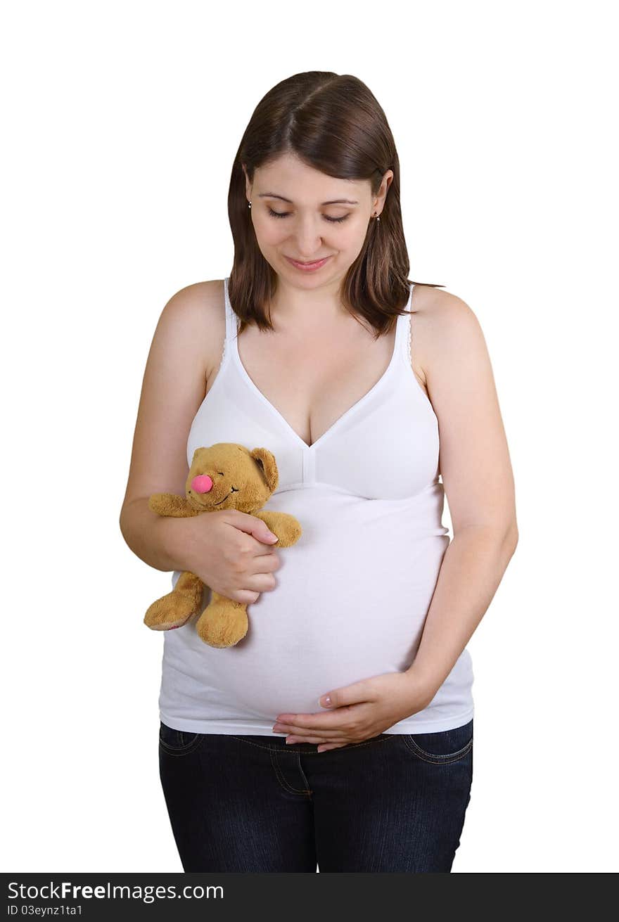 Smiling young pregnant woman with teddy bear