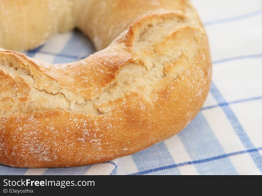 Fresh bread on the checkered towel. Close up