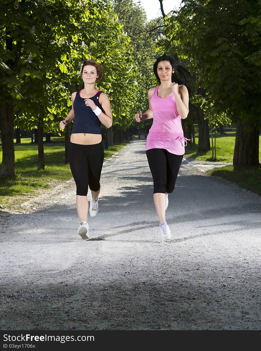 Young girls jogging running in the park. Young girls jogging running in the park