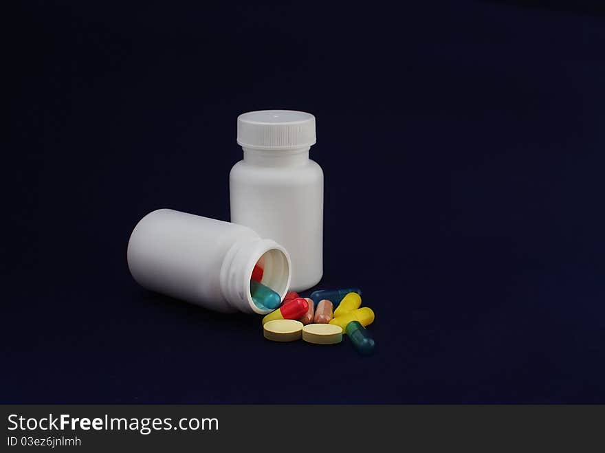 Colorful capsules and pills with packaging on pure backround. Colorful capsules and pills with packaging on pure backround