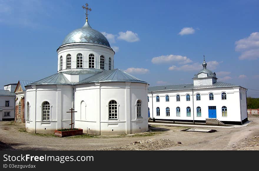 White buildings provoslavnoy church under the blue sky. White buildings provoslavnoy church under the blue sky