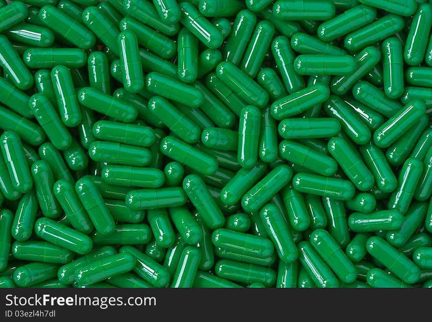 Many green capsule pills background