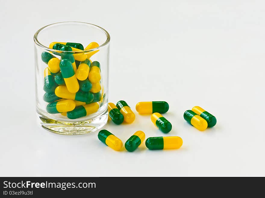 Capsule pills in a glass