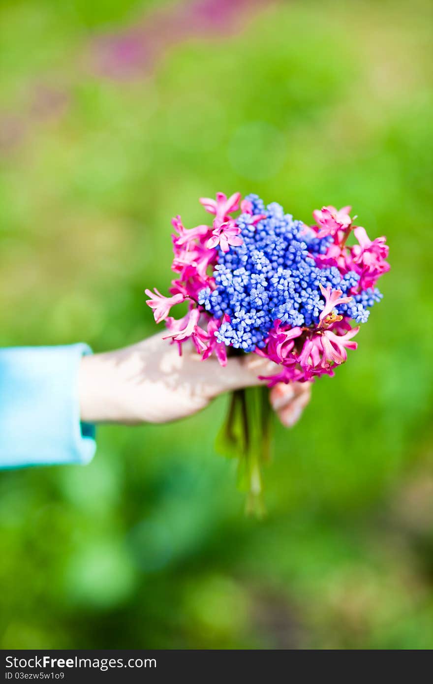 Woman holding flowers bouquet on green background