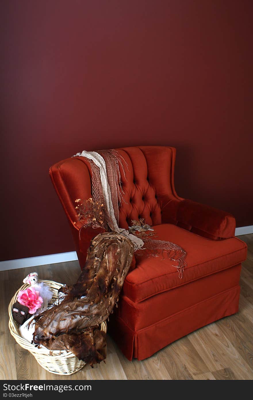 Red chair with basket on wooden floor