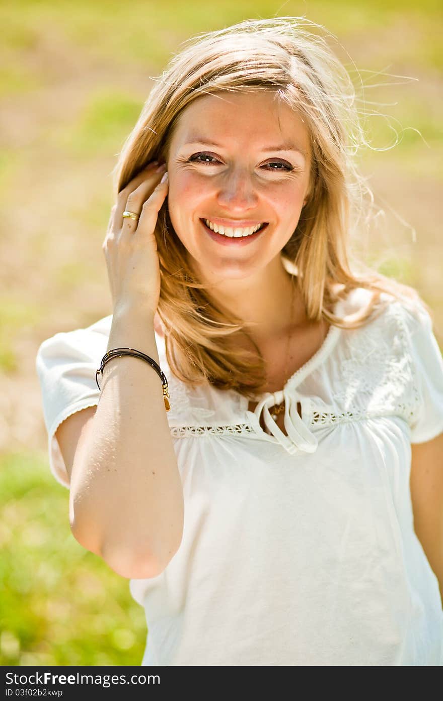 Pregnant woman outdoor in park at spring time