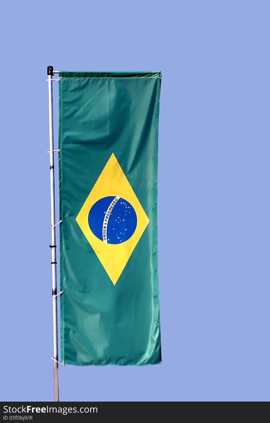 Brazilian flag with a blue sky