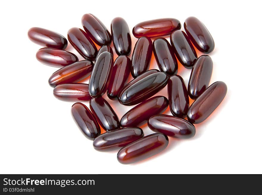 A heap of brown pills. A heap of brown pills