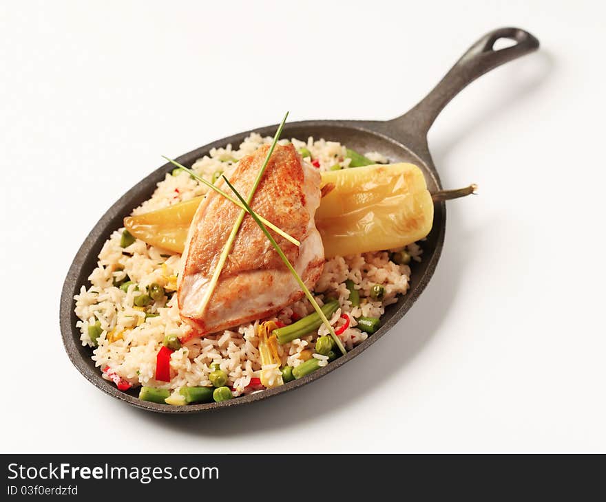 Fried rice and roasted chicken breast on a skillet. Fried rice and roasted chicken breast on a skillet