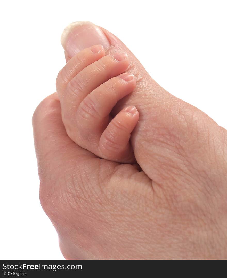 A baby clinging on to her mothers finger. A baby clinging on to her mothers finger