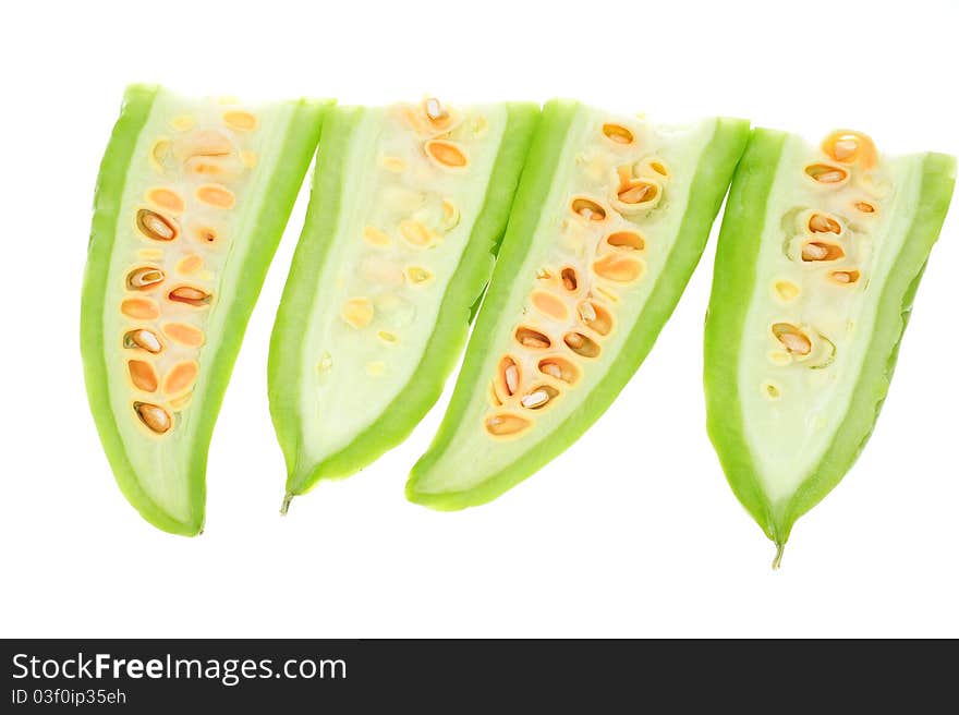 Sectional Cut Of Bitter Gourd Showing The Seeds, Image Is Isolated On White Background