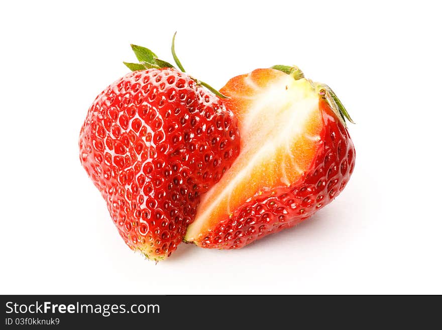 Strawberries cut in half on a white background.