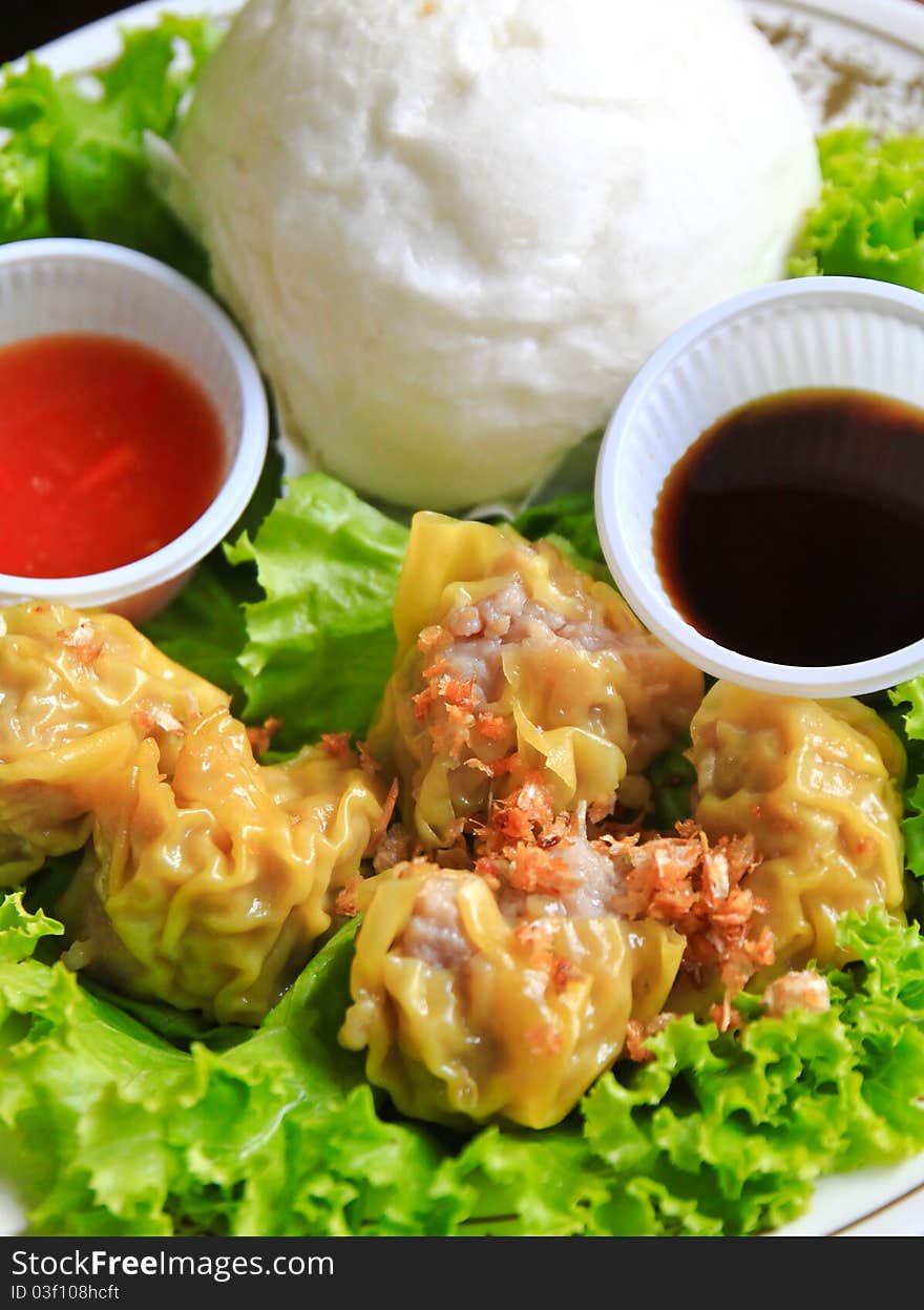 Chinese steamed dumplings and bun with sauce