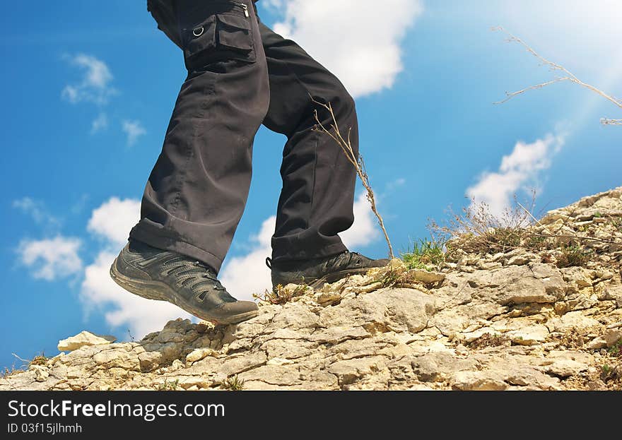 Legs of climber in mountain. Element of design.