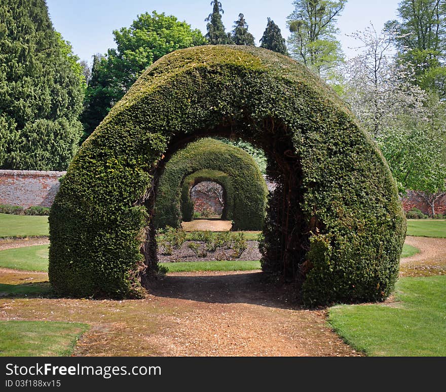 Row of Archways in an English Walled Garden