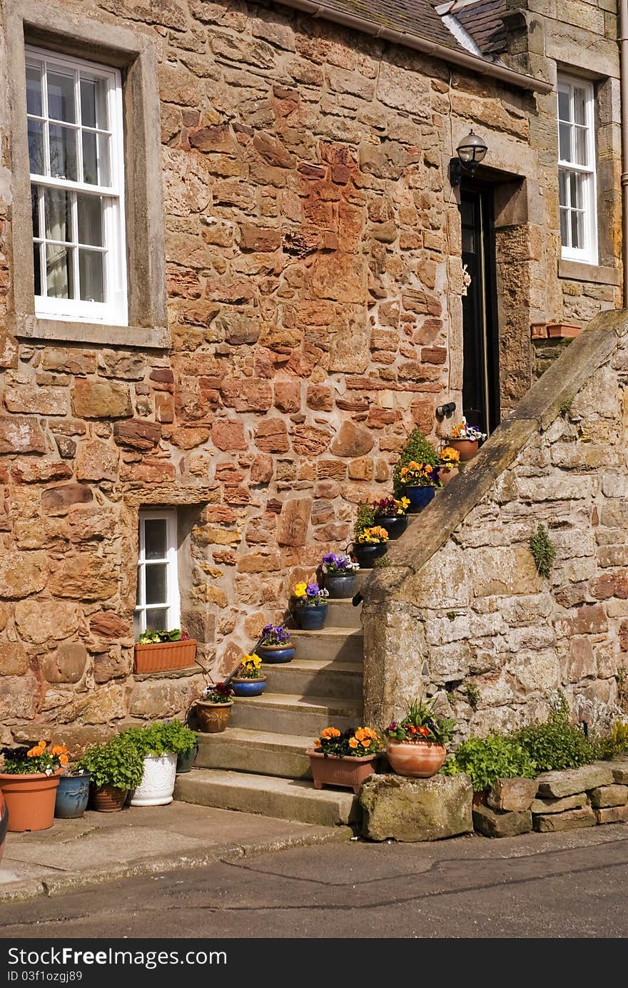 A vertical image of an old house in a fishing village on the east coast of scotland. A vertical image of an old house in a fishing village on the east coast of scotland