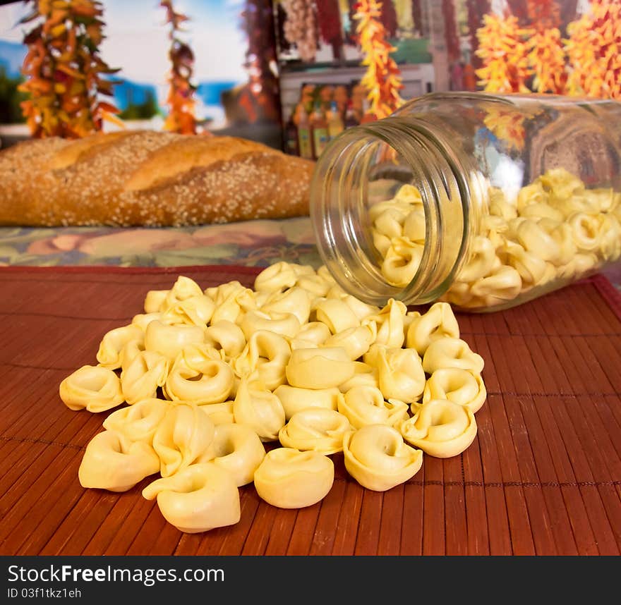 Italian cuisine; tortellini pasta from a jar with Italian bread in the background