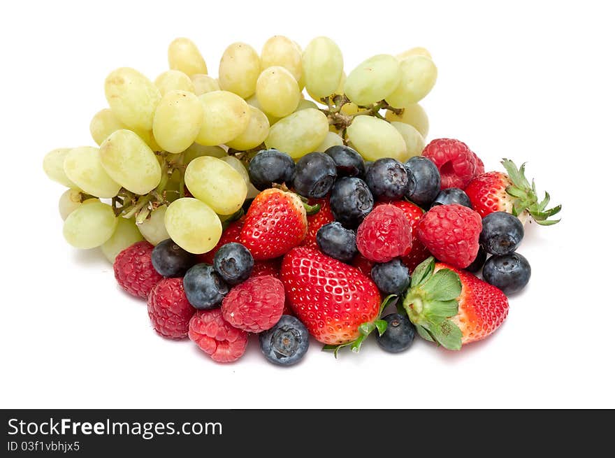 Some berries and grapes over a white background