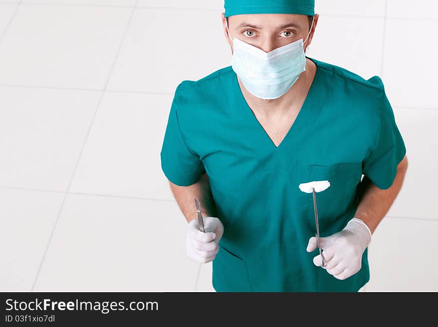 Surgeon in mask and gloves with the tools. Surgeon in mask and gloves with the tools