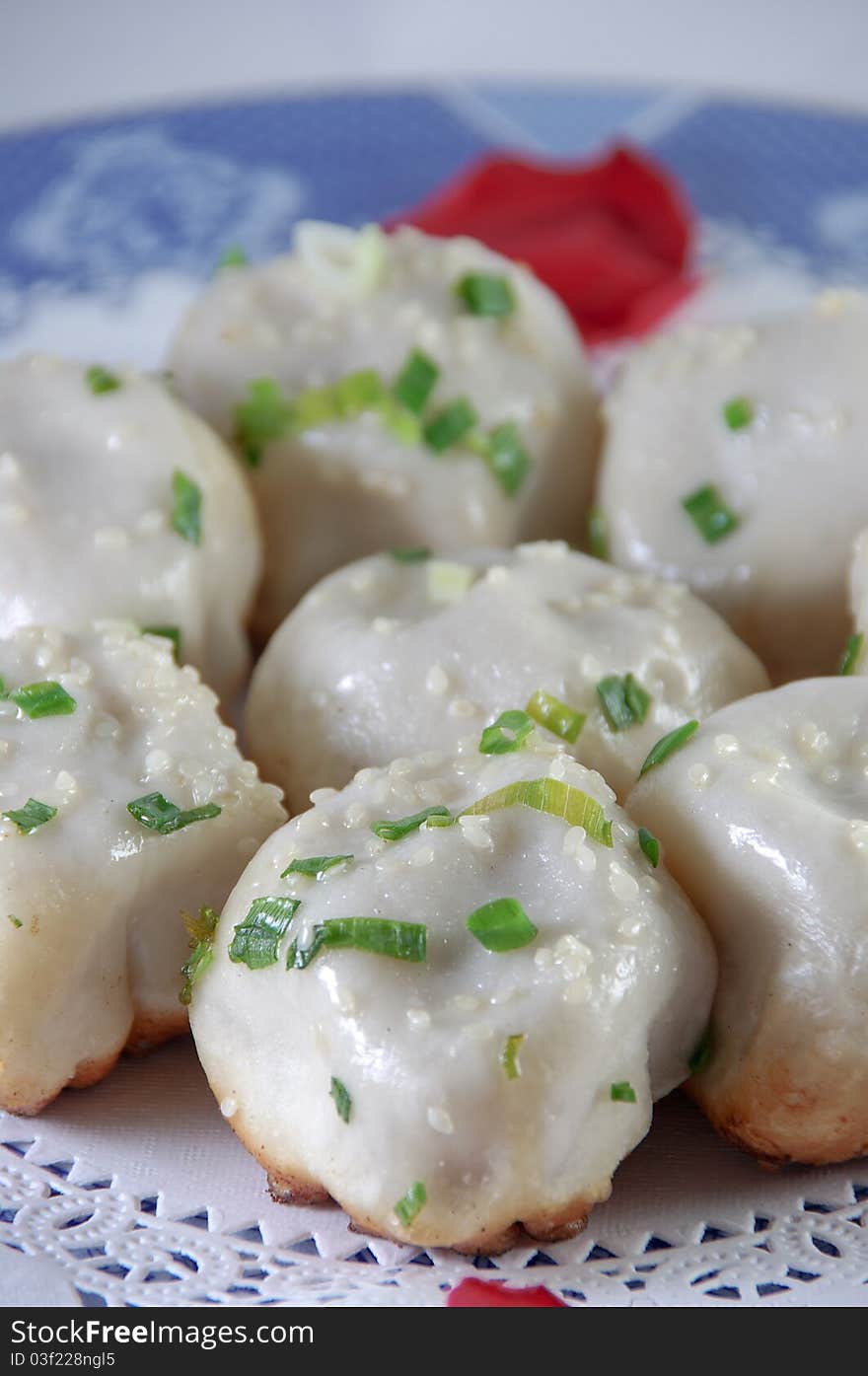 Chinese characteristic fried bun on a porcelain plate. Chinese characteristic fried bun on a porcelain plate