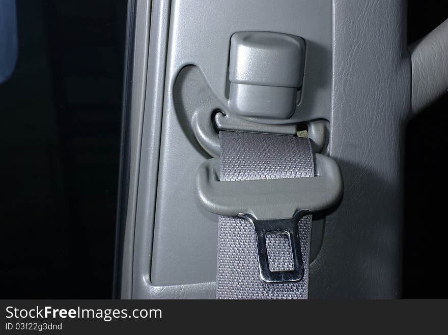 Car seatbelt on the grey background