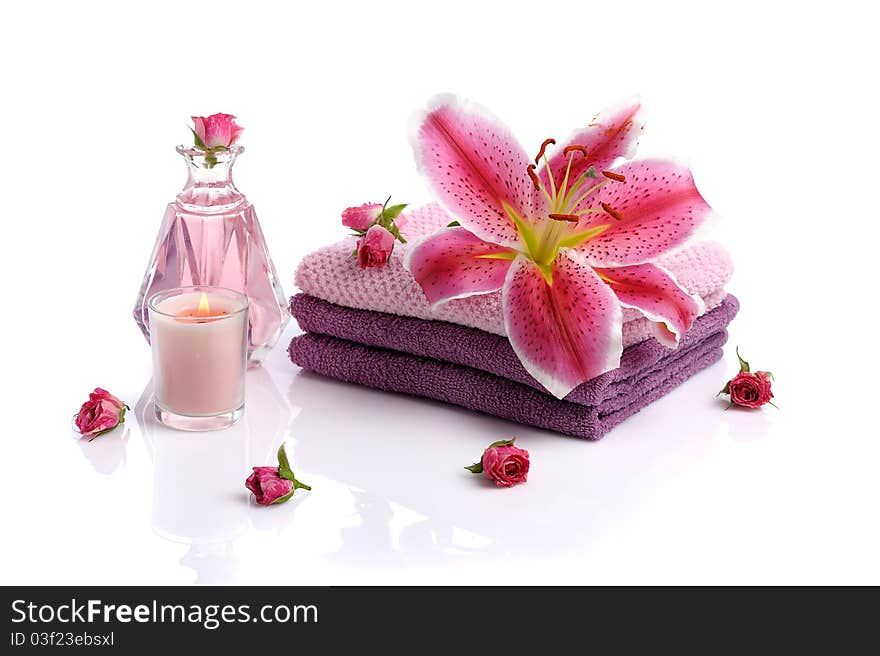 Bowl with rose petals, rose candle and towels on white background. Bowl with rose petals, rose candle and towels on white background