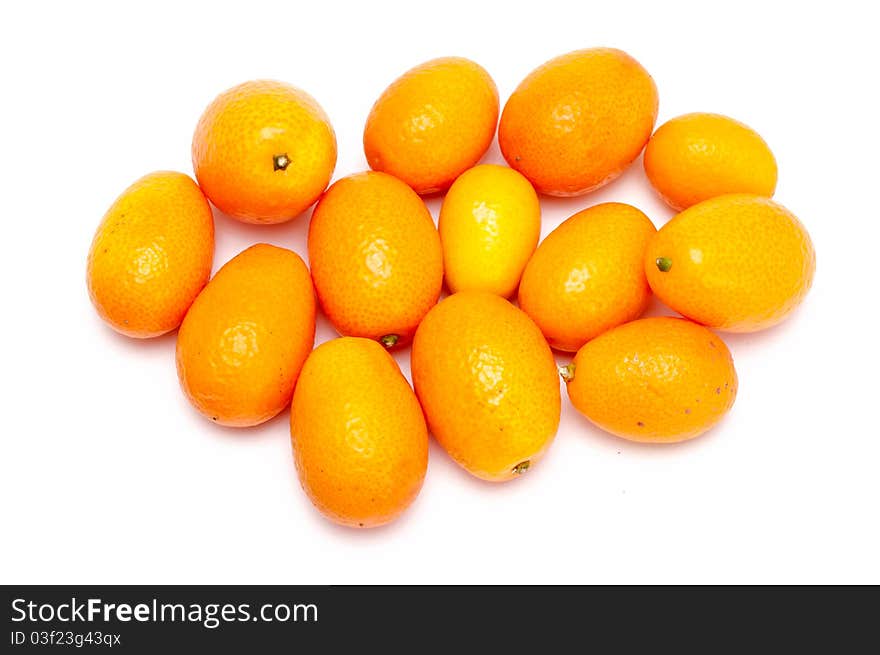 Some fresh kumquats over a white background