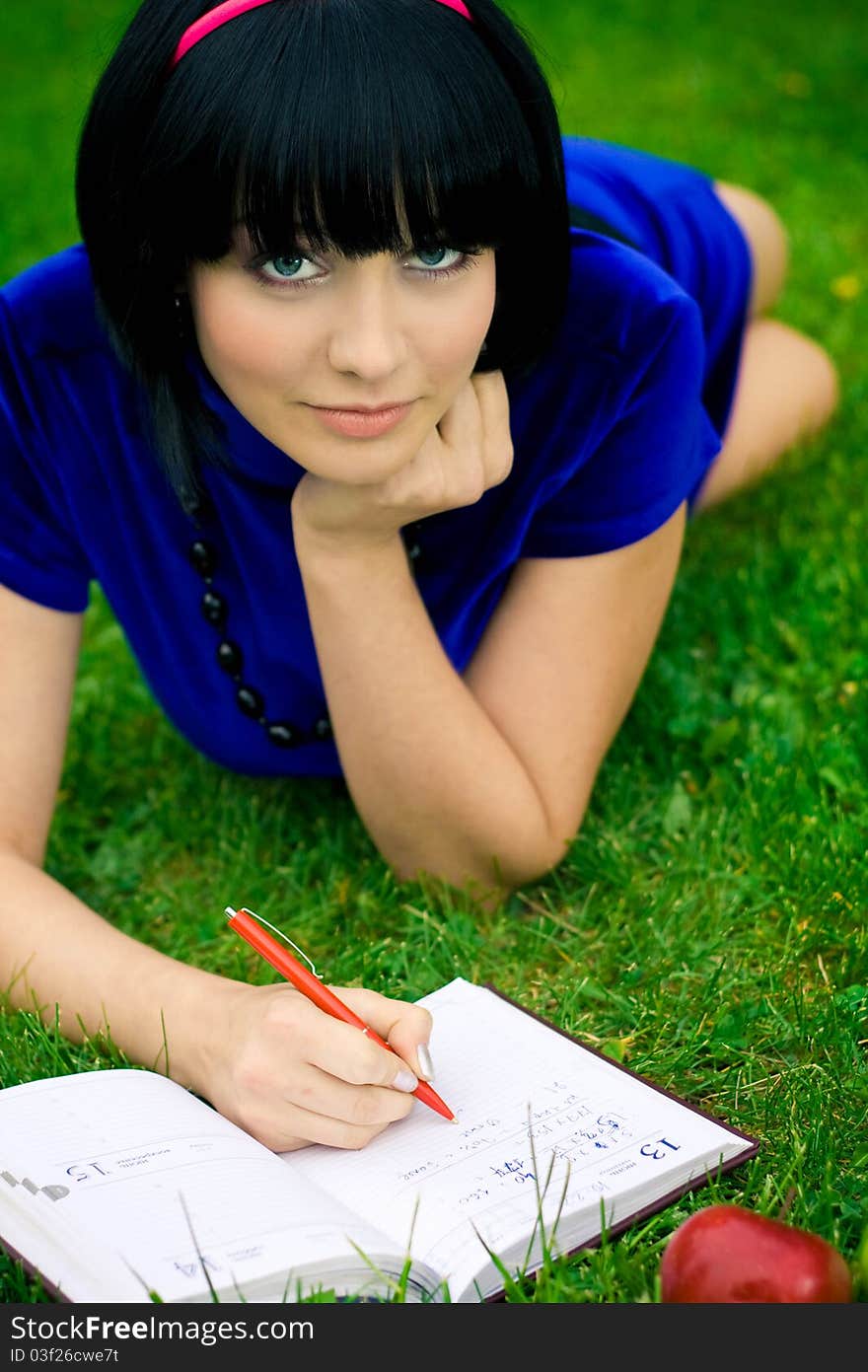 Happy woman with book outdoors