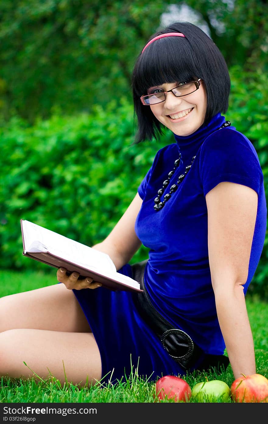 Happy woman with book outdoors