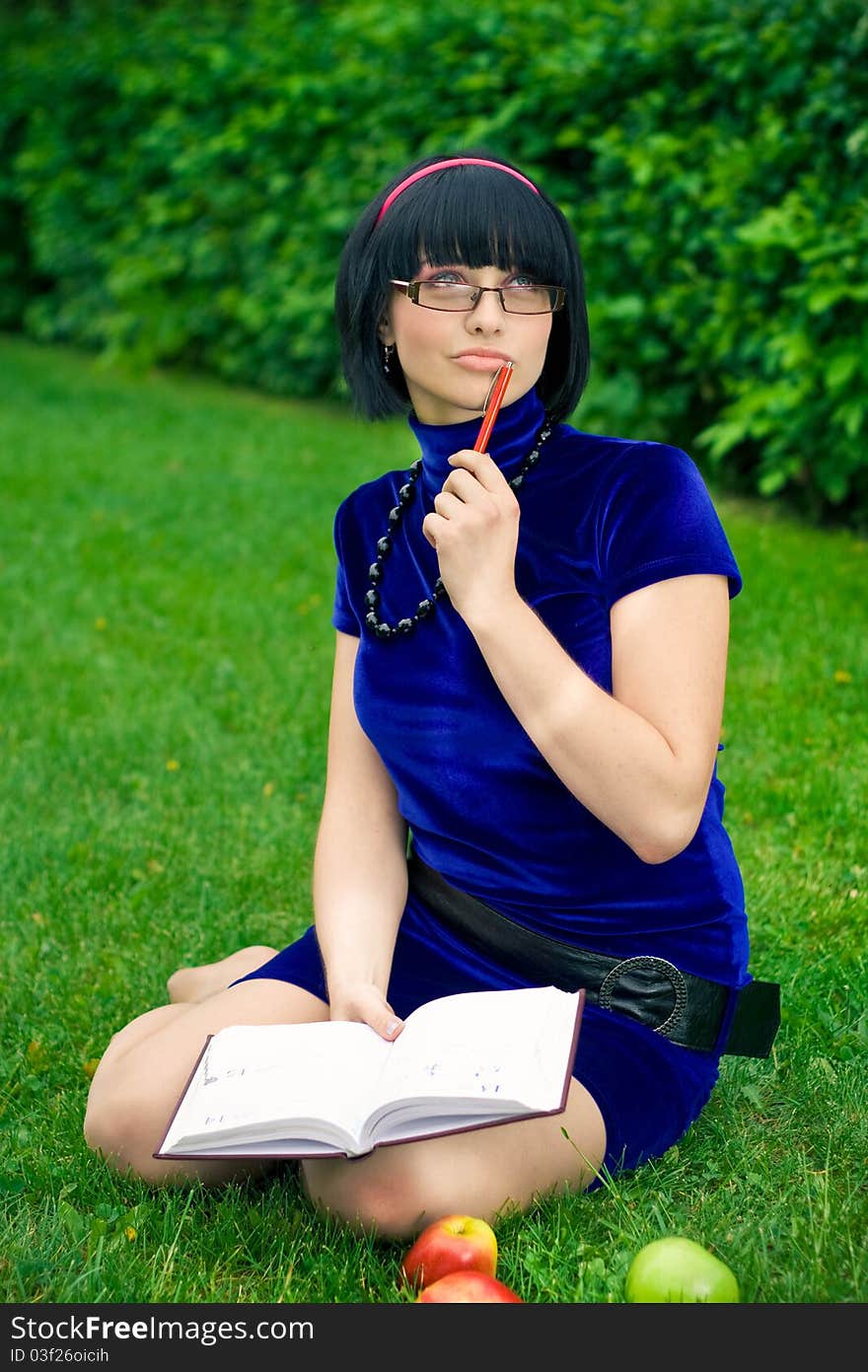 Happy woman with book outdoors