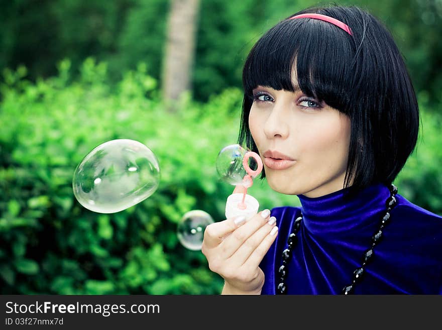 Woman blowing bubbles