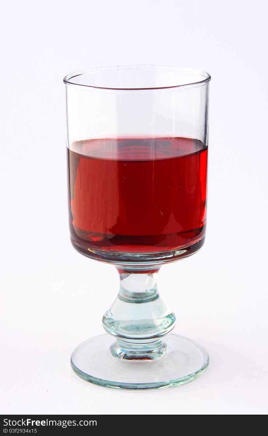 A single glass of red wine, isolated on white