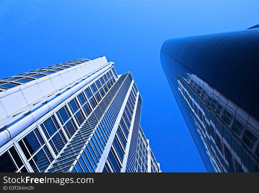 Wide angle shot of 2 buildings from the city scene, image has added blue filter effect for amore blue,crisp,clean look. Wide angle shot of 2 buildings from the city scene, image has added blue filter effect for amore blue,crisp,clean look.