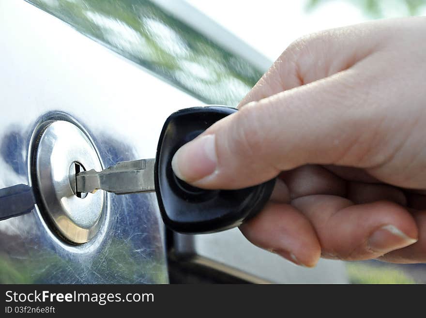 Key in the keyhole of a car