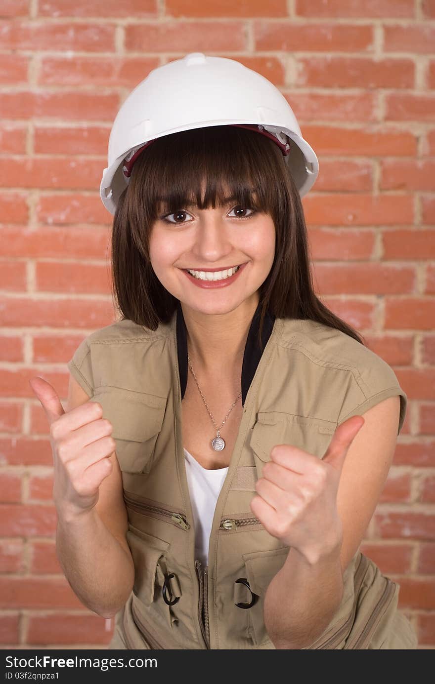 Pretty girl in a helmet against a red wall